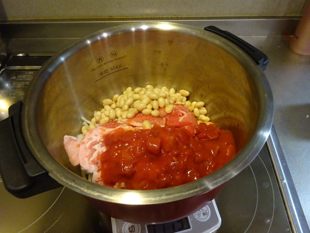 鍋に豚肉、大豆の水煮、玉ねぎ、トマト缶投入